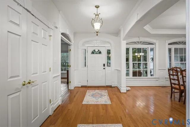 a view of a hallway with wooden floor and staircase