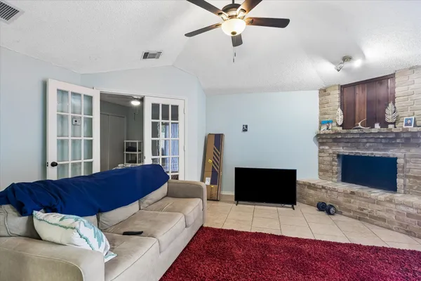 a living room with furniture a flat screen tv and a fireplace