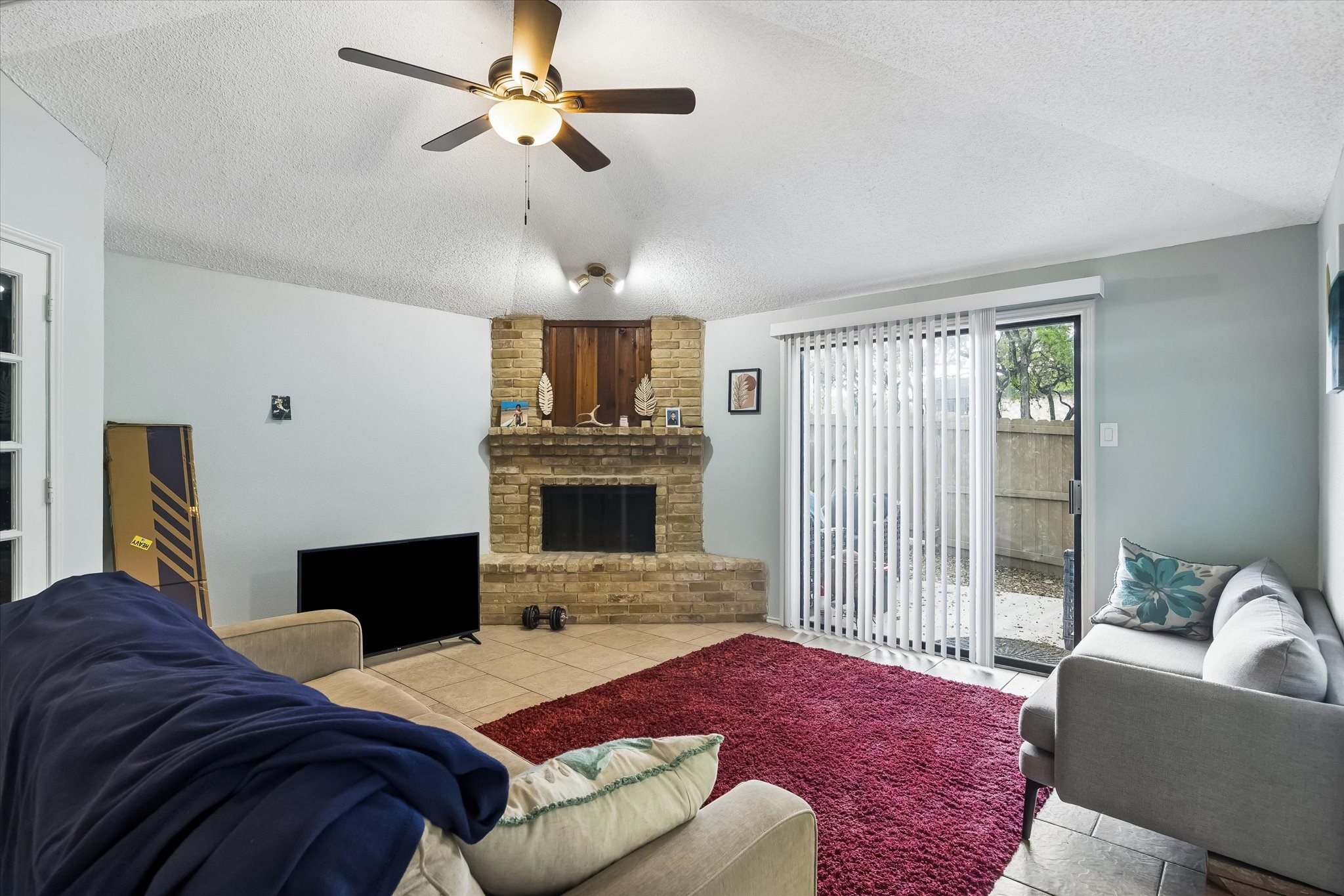 13533 George Road San Antonio, TX 78230 - Photo 12 of 34 a bedroom with a bed wooden floor and a fireplace