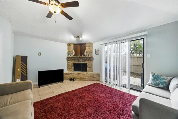 a living room with furniture a fireplace and a flat screen tv