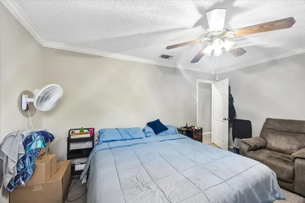 a bedroom with a bed and chandelier