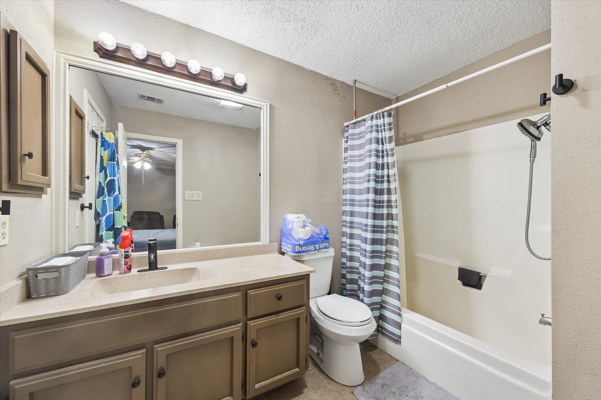 13533 George Road San Antonio, TX 78230 - Photo 20 of 34 a bathroom with a sink a toilet a mirror and shower