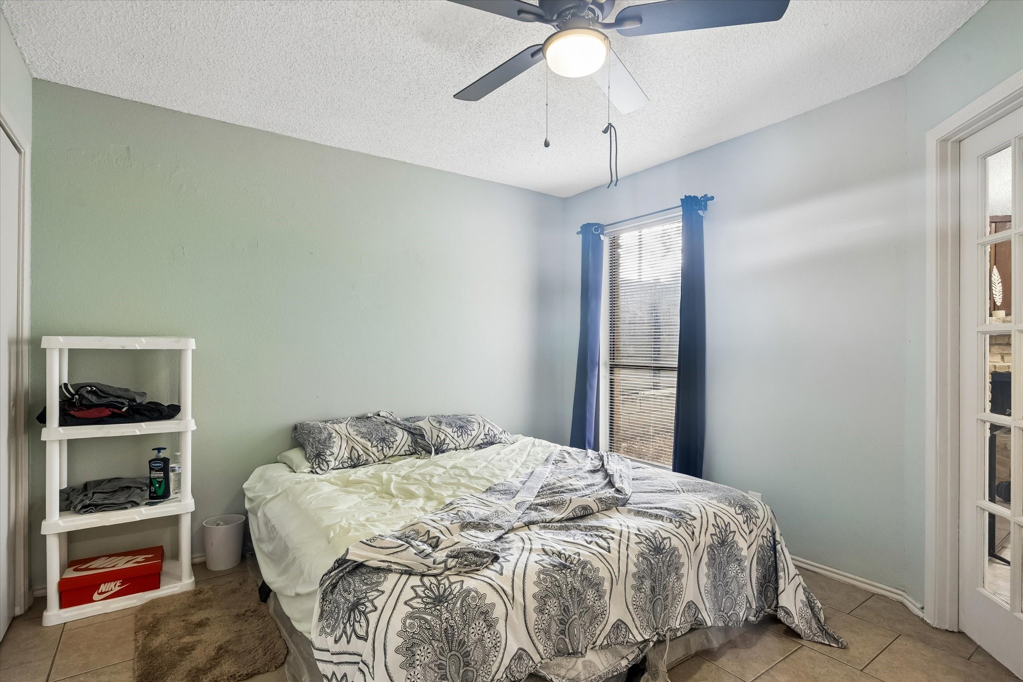 13533 George Road San Antonio, TX 78230 - Photo 21 of 34 a bedroom with a bed and a chandelier