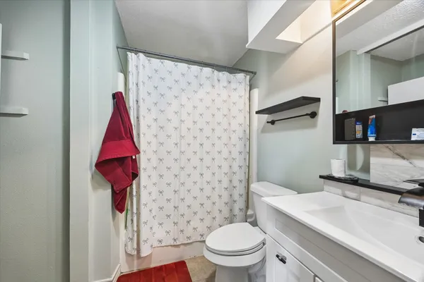 a bathroom with a sink toilet and shower