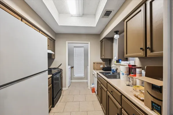 a kitchen with a refrigerator and a sink