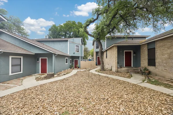 a view of a house with a patio and yard