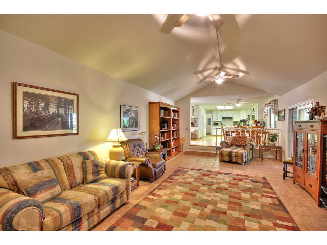 1300 Day Road Gilroy, CA 95020 - Photo 15 of 25 a living room with furniture large mirror and a chandelier