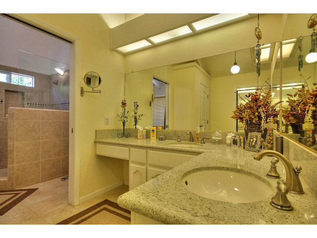 1300 Day Road Gilroy, CA 95020 - Photo 20 of 25 a bathroom with a sink mirror and a bathtub