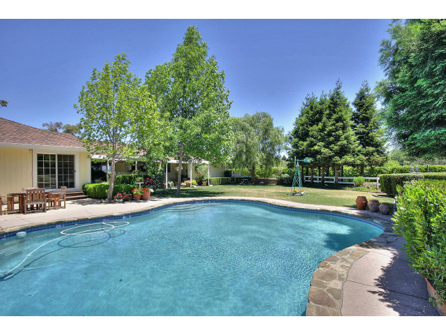 1300 Day Road Gilroy, CA 95020 - Photo 7 of 25 a view of a house with swimming pool and a yard