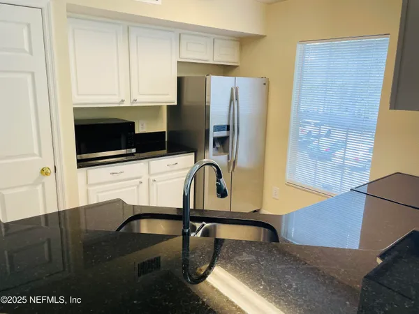 a kitchen with stainless steel appliances wooden cabinets a stove and a refrigerator