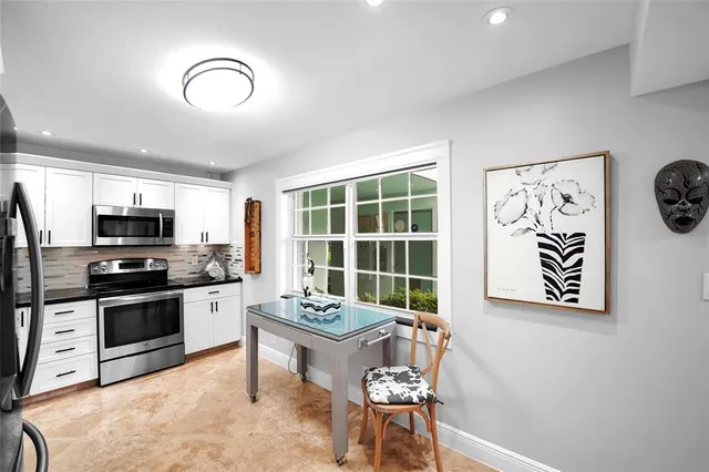 a view of a dining room with furniture and a chandelier