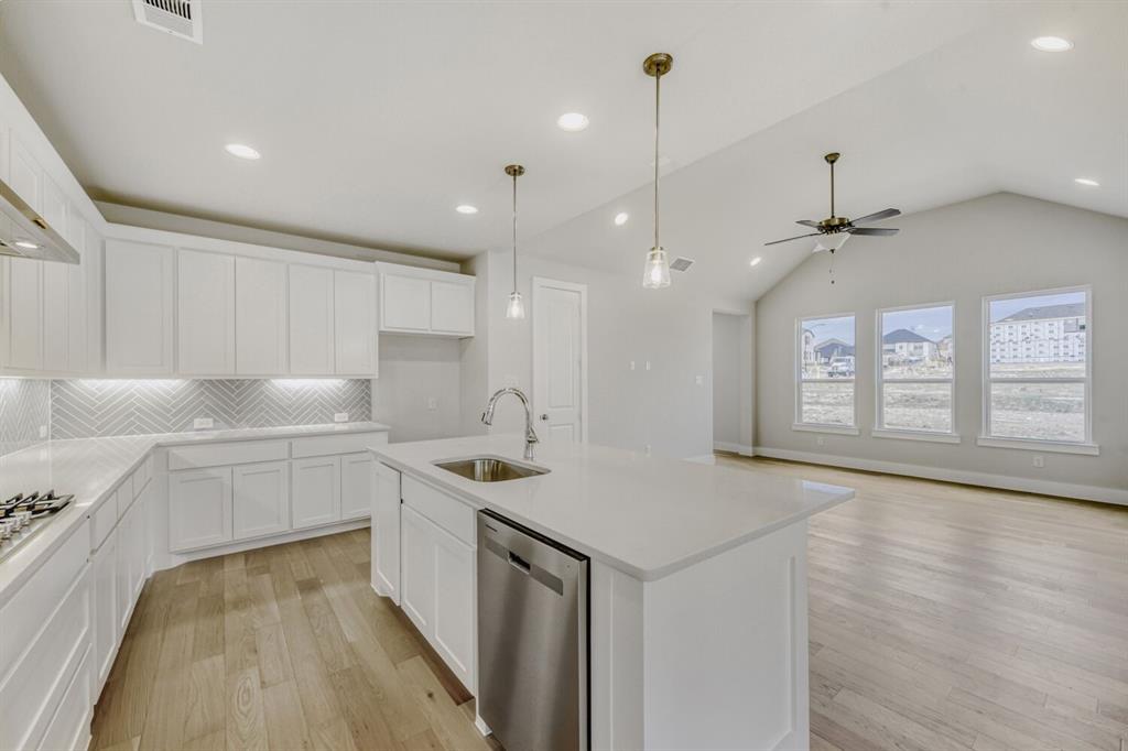 6033 Davis Knoll Road Fort Worth, TX 76126 - Photo 14 of 29 a kitchen with a sink a counter top space stainless steel appliances and a window