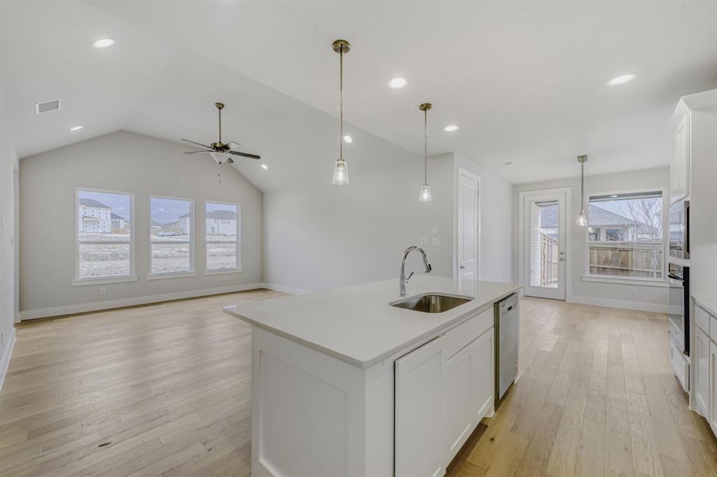 6033 Davis Knoll Road Fort Worth, TX 76126 - Photo 15 of 29 a kitchen with stainless steel appliances granite countertop a sink a stove and a wooden floors
