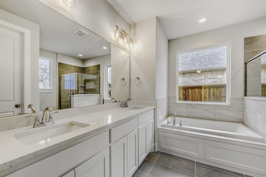 6033 Davis Knoll Road Fort Worth, TX 76126 - Photo 22 of 29 a bathroom with a sink double vanity granite tub shower and a mirror