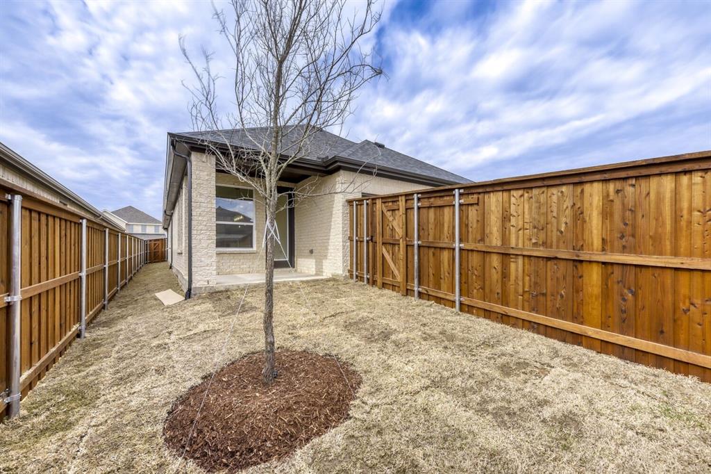 6033 Davis Knoll Road Fort Worth, TX 76126 - Photo 29 of 29 a view of a house with wooden fence and a large tree