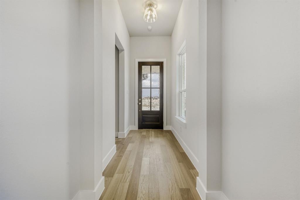 6033 Davis Knoll Road Fort Worth, TX 76126 - Photo 5 of 29 a view of a hallway with wooden floor