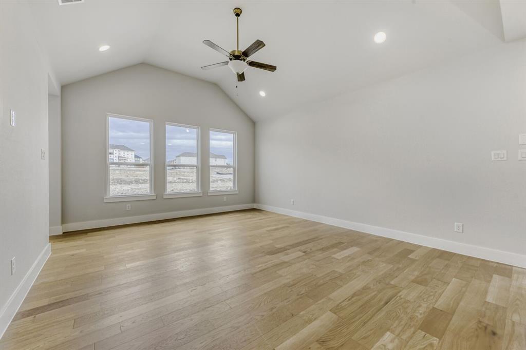 6033 Davis Knoll Road Fort Worth, TX 76126 - Photo 9 of 29 an empty room with wooden floor chandelier and windows
