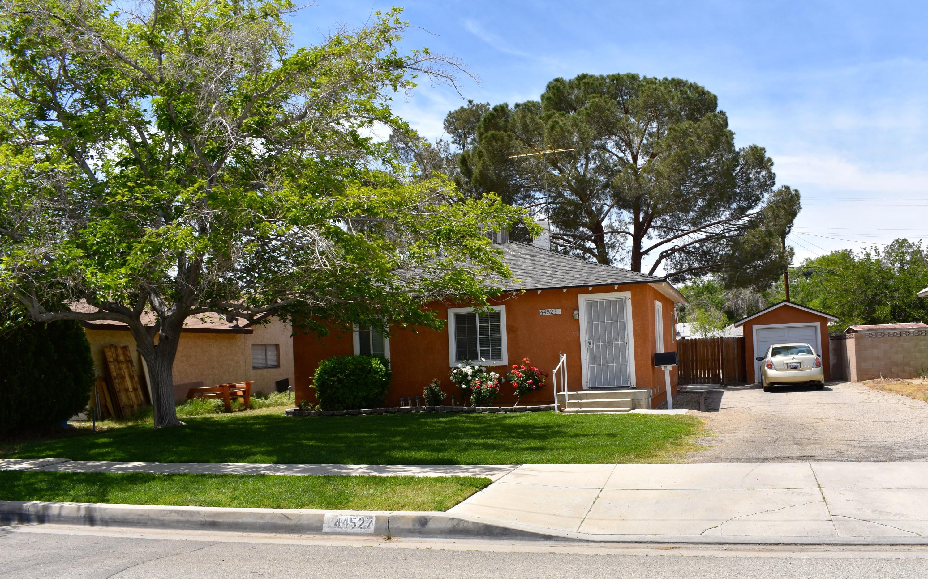 44527 Date Avenue Lancaster, CA 93534 - Photo 1 of 20 a front view of a house with garden