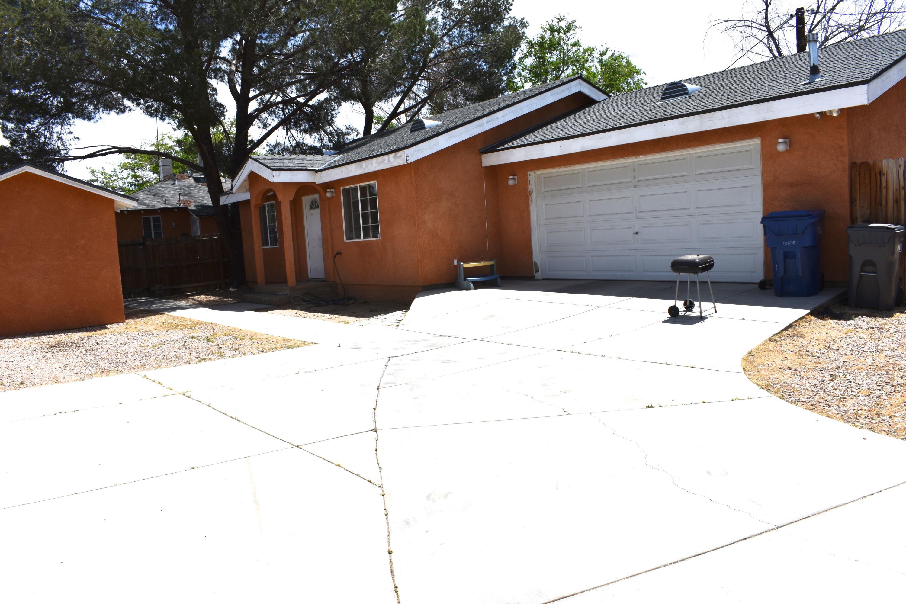 44527 Date Avenue Lancaster, CA 93534 - Photo 12 of 20 a backyard of a house with wooden fence and large trees