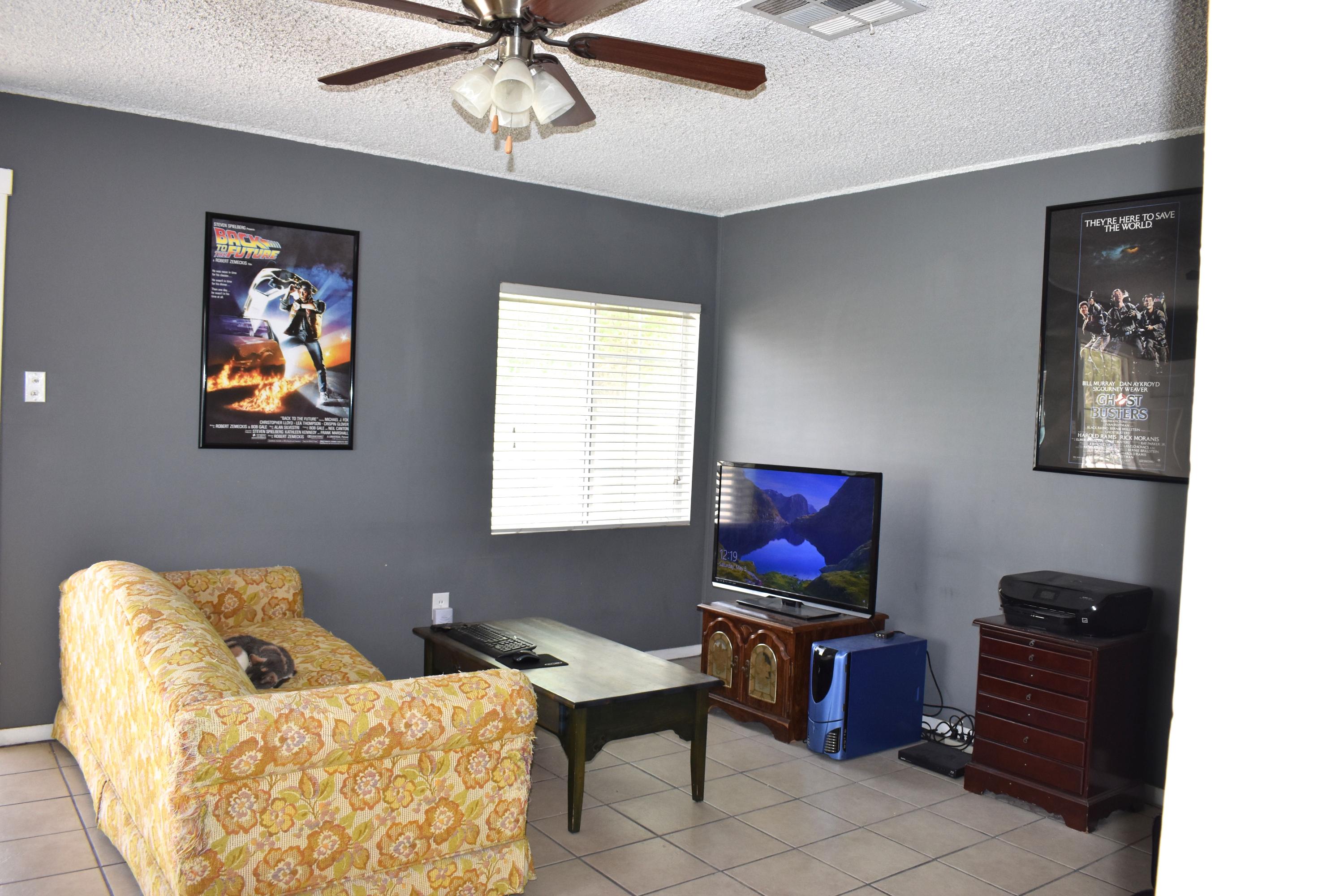 44527 Date Avenue Lancaster, CA 93534 - Photo 3 of 20 a living room with furniture and a flat screen tv