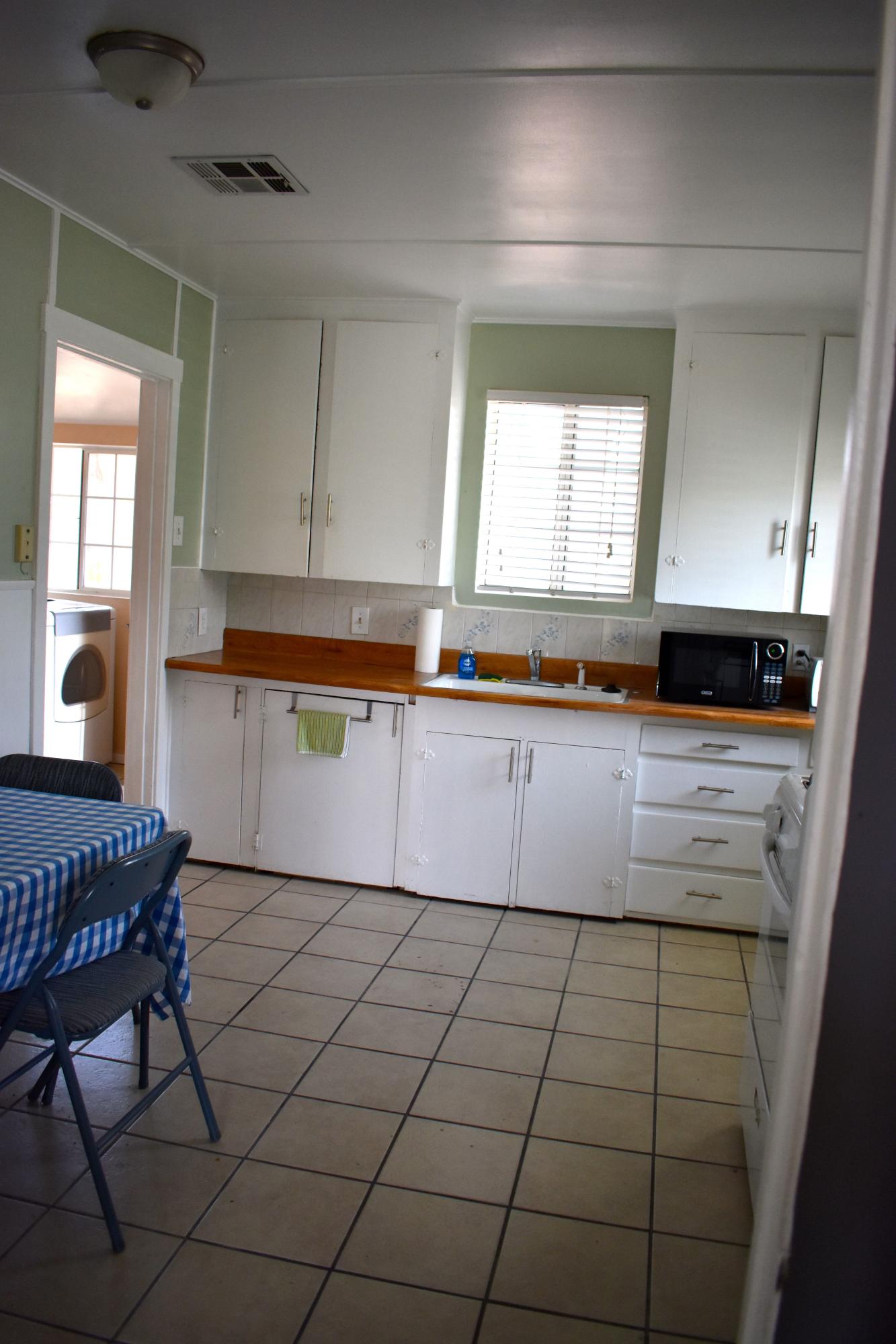 44527 Date Avenue Lancaster, CA 93534 - Photo 6 of 20 a kitchen with granite countertop a sink a stove cabinets and dining table