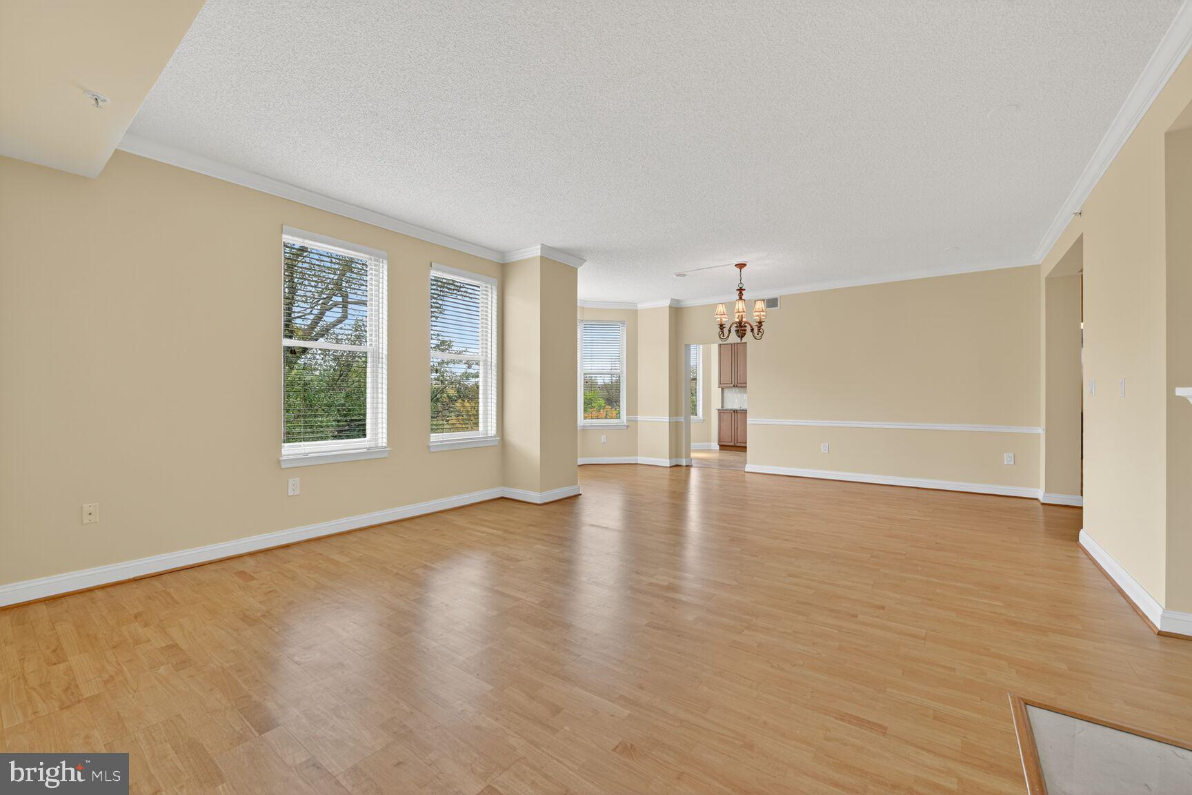 11776 Stratford House Place, Unit 507 Reston, VA 20190 - Photo 12 of 40 a view of an empty room with a window and wooden floor