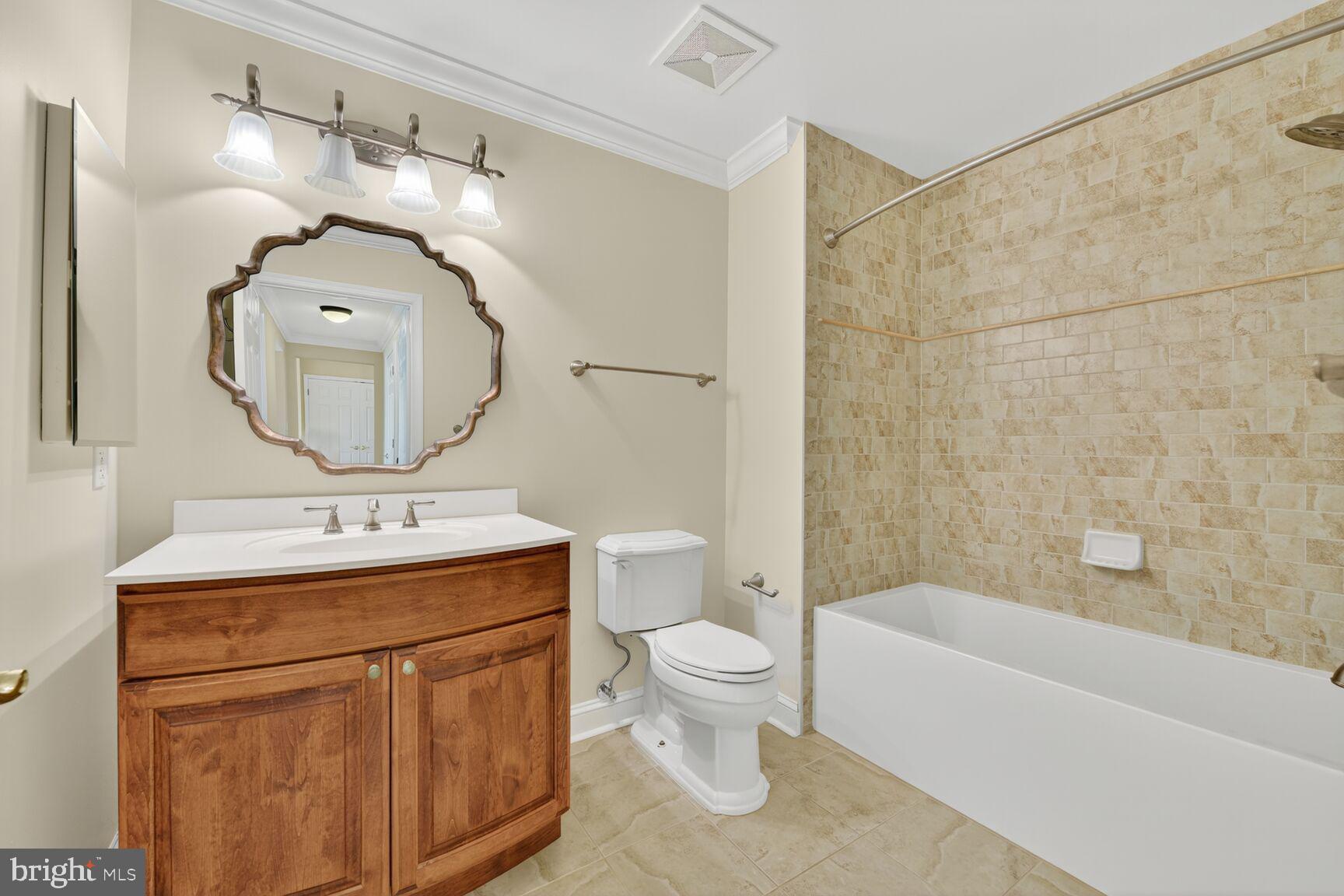 11776 Stratford House Place, Unit 507 Reston, VA 20190 - Photo 25 of 40 a bathroom with a toilet sink and mirror