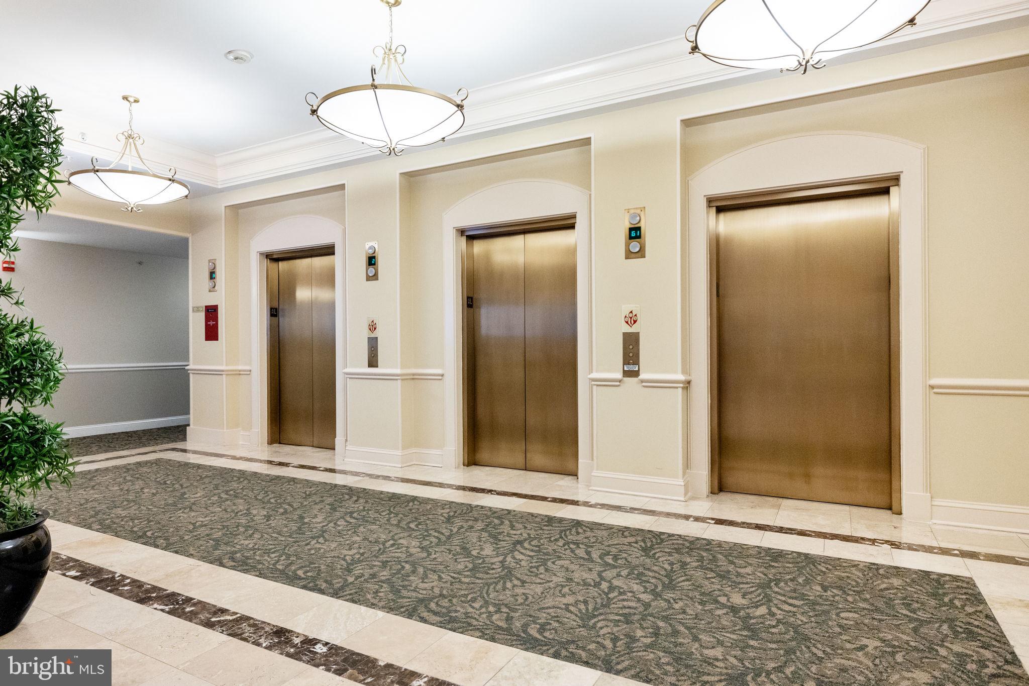 11776 Stratford House Place, Unit 507 Reston, VA 20190 - Photo 31 of 40 a view of a big room with wooden floor and a chandelier