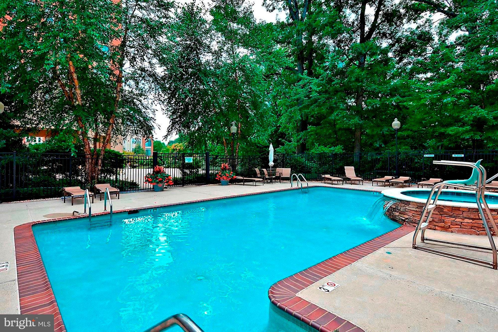 11776 Stratford House Place, Unit 507 Reston, VA 20190 - Photo 32 of 40 a view of a swimming pool with chairs