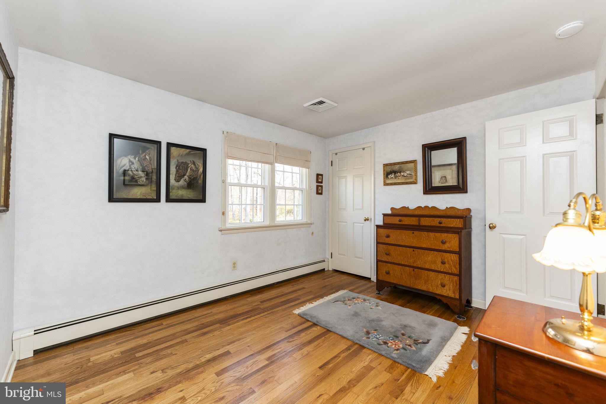 5101 Hiffletrayer Road Green Lane, PA 18054 - Photo 19 of 27 a bedroom with a bed and wooden floor