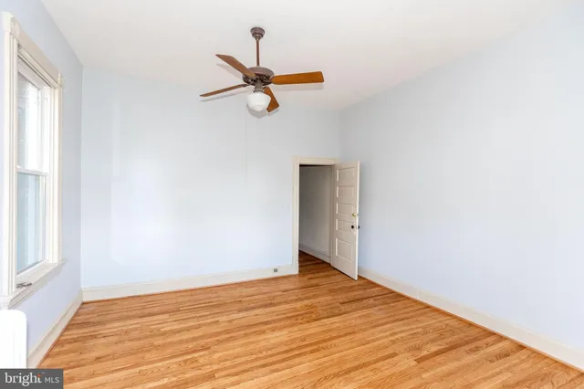 a view of a room with wooden floor and white walls