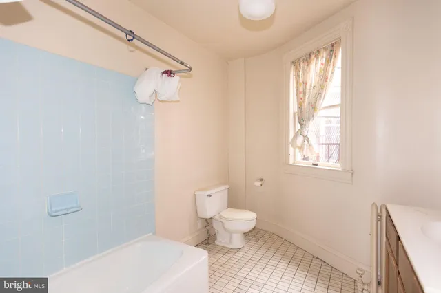 a bathroom with a toilet sink and window