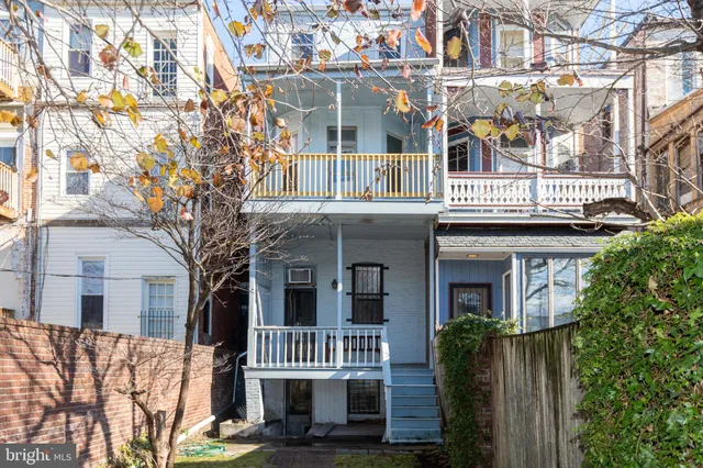 a front view of a house with a fence