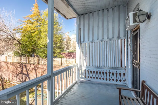 a view of a porch with wooden floor