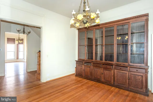 a view of a room with wooden floor and large windows
