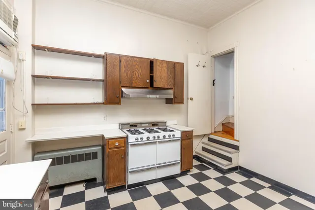 a kitchen with a stove a sink and a microwave