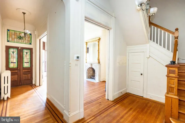 a view of a hallway view with wooden floor and staircase