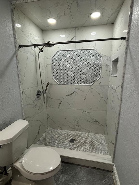 7185 Holiday Drive Spring Hill, FL 34606 - Photo 16 of 25 a bathroom with a toilet and a shower