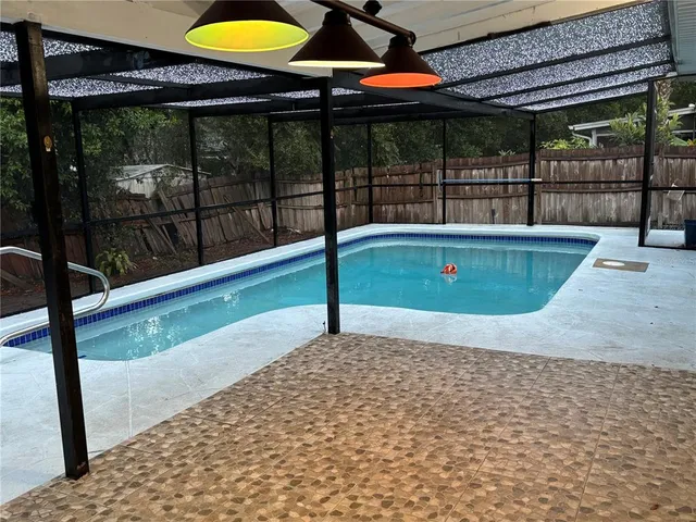a view of a swimming pool with a patio