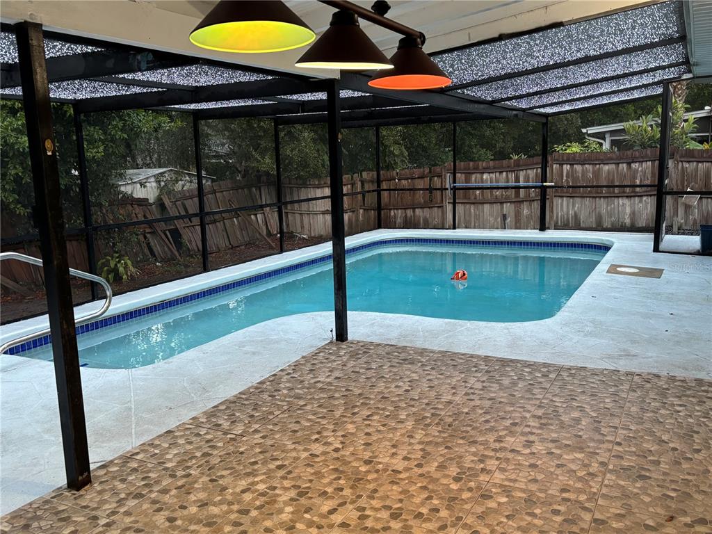 7185 Holiday Drive Spring Hill, FL 34606 - Photo 17 of 25 a view of a swimming pool with a porch