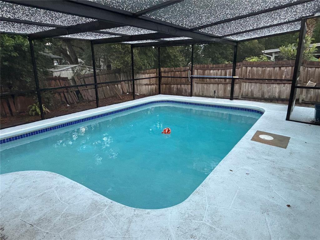 7185 Holiday Drive Spring Hill, FL 34606 - Photo 18 of 25 a view of a swimming pool with a patio