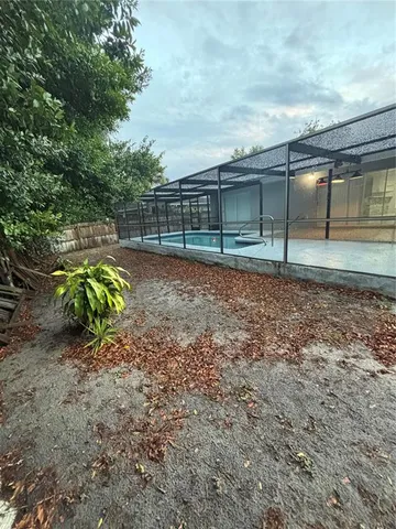 a view of backyard with wooden fence