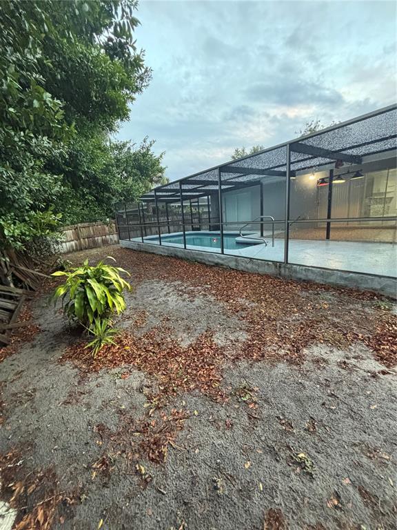7185 Holiday Drive Spring Hill, FL 34606 - Photo 22 of 25 a backyard of a house with lots of green space