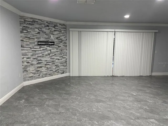 a view of an empty room and a window