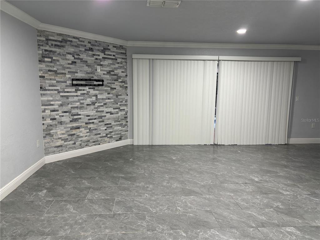 7185 Holiday Drive Spring Hill, FL 34606 - Photo 3 of 25 a view of an empty room and a window