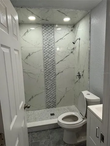 a bathroom with a toilet and shower