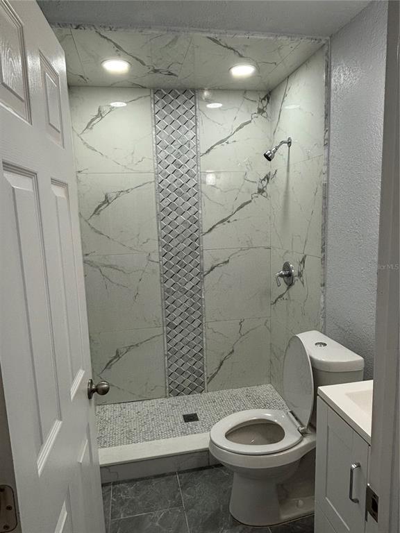 7185 Holiday Drive Spring Hill, FL 34606 - Photo 7 of 25 a bathroom with a toilet and shower