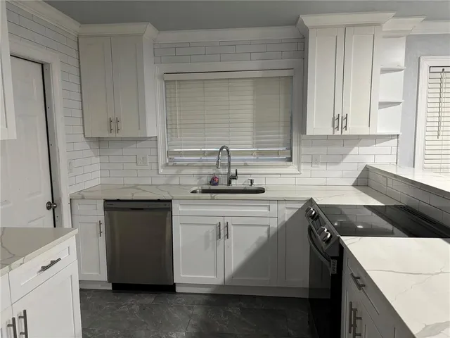 a kitchen with a sink and cabinets