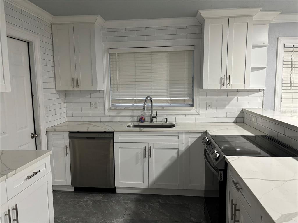 7185 Holiday Drive Spring Hill, FL 34606 - Photo 8 of 25 a kitchen with a sink and cabinets