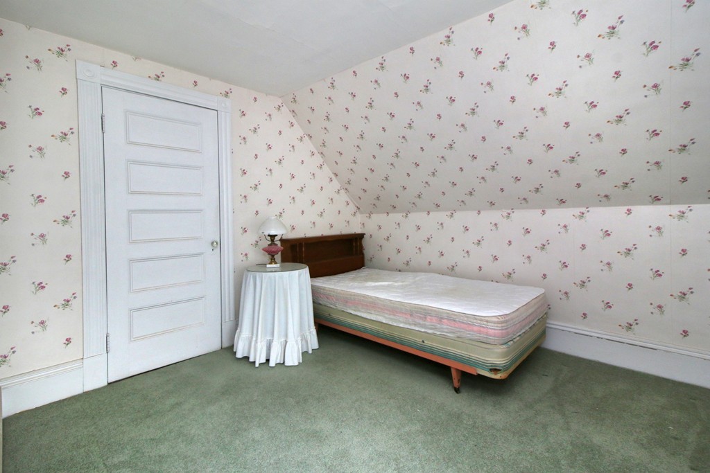 5 Pearson Road Somerville, MA 02144 - Photo 14 of 17 a spacious bedroom with a bed and a cabinet